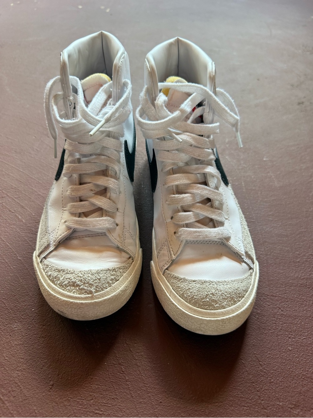 Nike White High-Top Sneakers with Black Swoosh